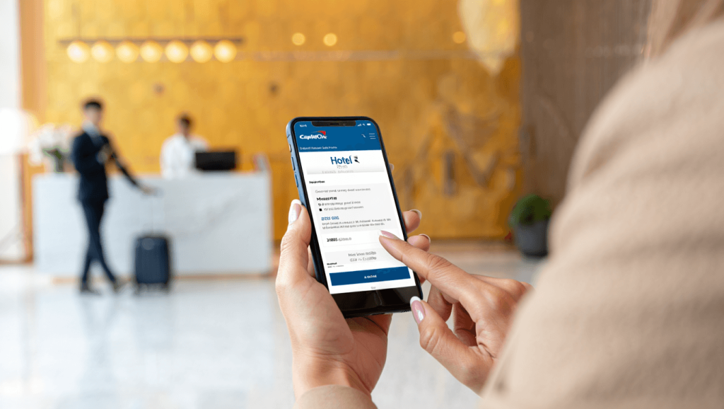 A hand holding a wallet with the Capital One Venture and Venture X credit cards.