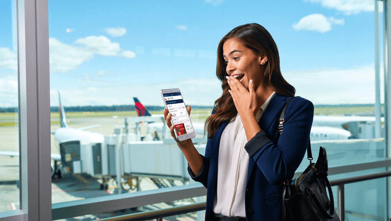 delta planes on tarmac from a patio with seating in the foreground