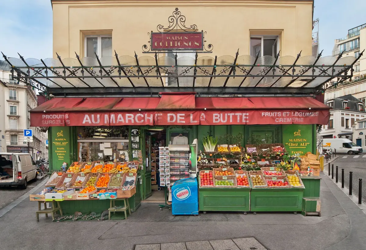 Marché provençal avec étals de produits frais et terrasse de café