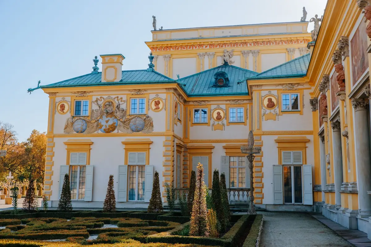 Couloir de palais avec fenêtres donnant sur les jardins à l'heure dorée