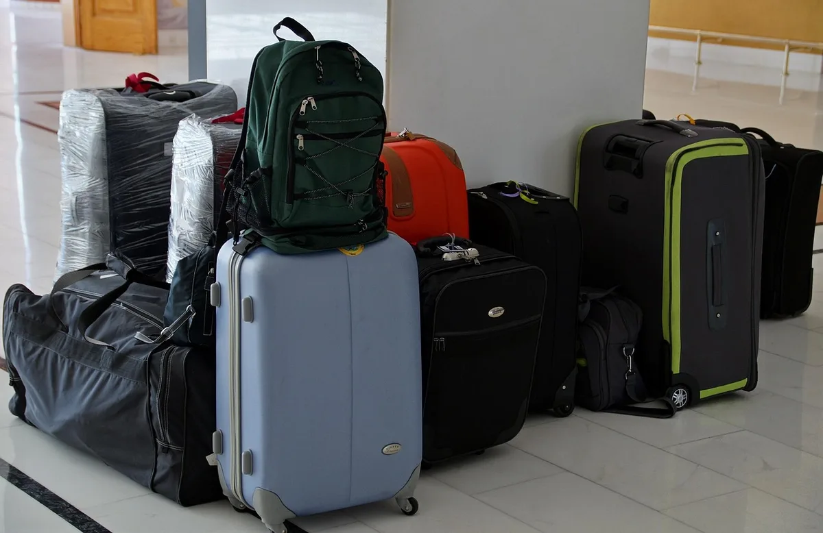 Sac de jour ouvert avec bouteille d'eau, chargeur et protection solaire